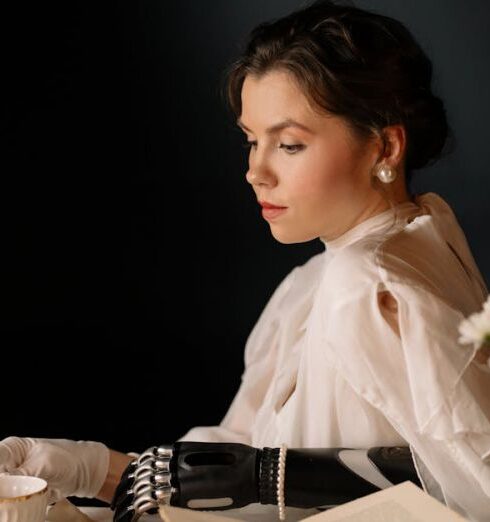 Clutch - Woman in White Long Sleeve Shirt Sitting by the Table