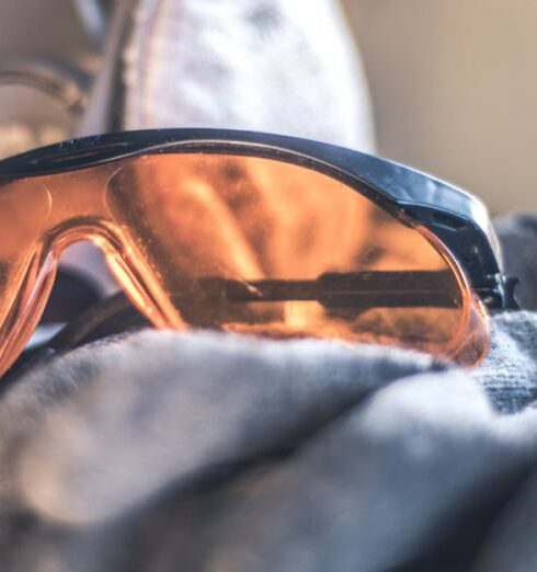 Gloves - Closeup Photo of Black Framed Brown Sunglasses