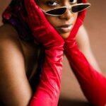 Sunglasses - Woman in Red Satin Gloves Wearing Black Sunglasses