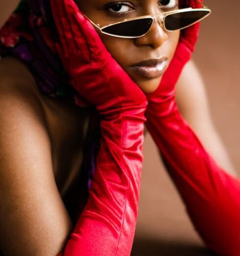 Sunglasses - Woman in Red Satin Gloves Wearing Black Sunglasses