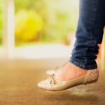 Flats - Person Wearing Beige Flats While Sitting on Bench