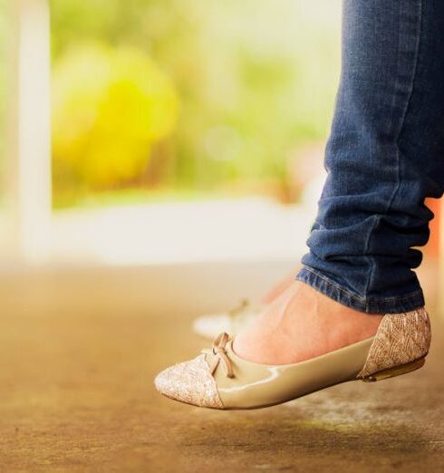 Flats - Person Wearing Beige Flats While Sitting on Bench