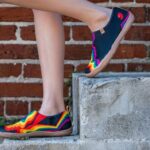 Espadrilles - A woman in colorful shoes standing on some steps