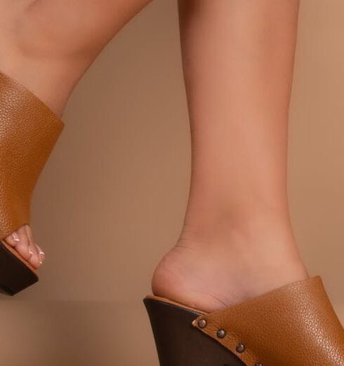 Mules - The legs of a woman wearing brown mules