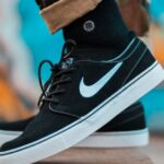 Sneakers - Person in Brown Camouflage Pants and Black Nike Sb Stefan Janoski With Black Socks