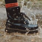 Boots - Water Splashing From A Person In Black Workers Boots Stepping On Wet Pavement