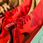 Shoes - Focus Photography of Pair of Red Nike Running Shoes