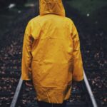 Raincoat - Photo of Person Wearing Raincoat in a Railway