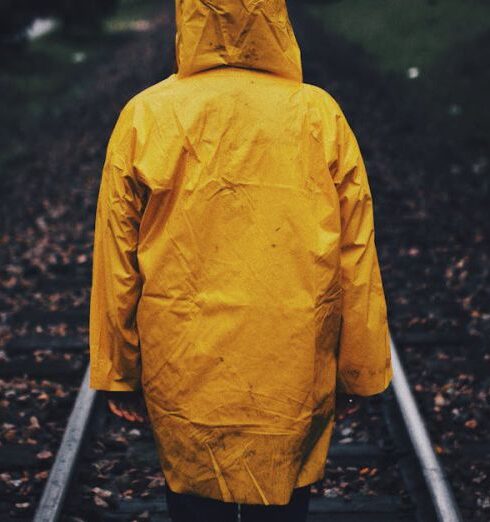 Raincoat - Photo of Person Wearing Raincoat in a Railway