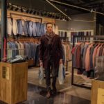 Jackets - Man in Black Leather Jacket Standing in Front of Clothes Rack