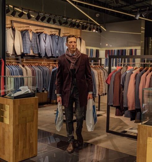 Jackets - Man in Black Leather Jacket Standing in Front of Clothes Rack