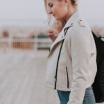 Jacket - Woman in Black Zip-up Jacket With Black Backpack