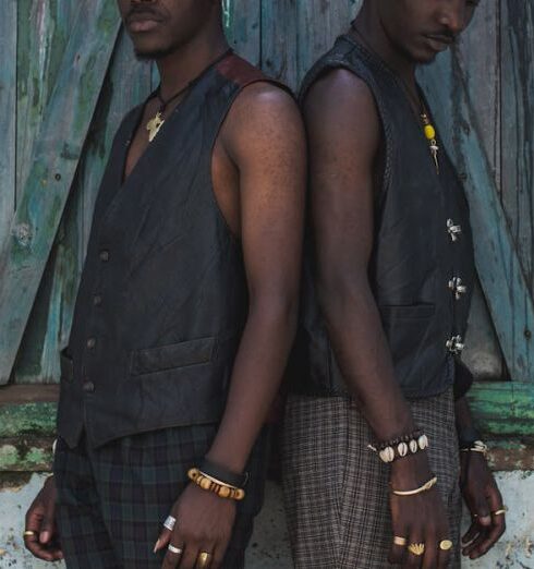 Vests - Two men standing next to each other in front of a window