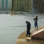 Jackets - People fishing on the edge of a river