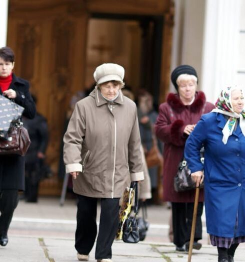 Coats - Women walk past a church in the old town of moscow