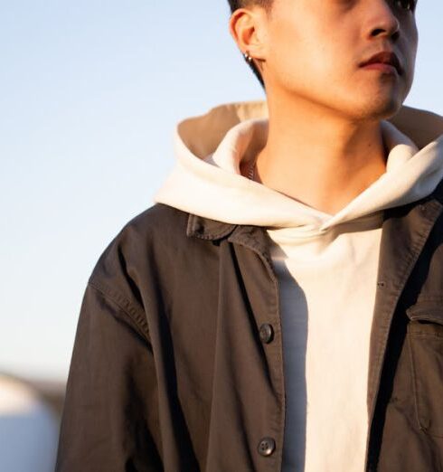 Shackets - Young Man Posing in Black Shacket and White Hooded Sweatshirt