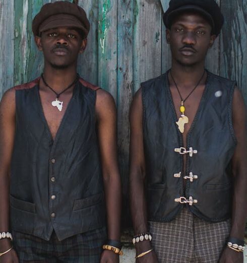 Vests - Two men stand in front of a blue window