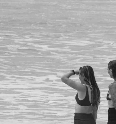 Bikinis - Women and Surfboard on Beach