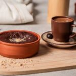 Cover-Ups - A wooden tray with two cups of coffee and a bowl of chocolate