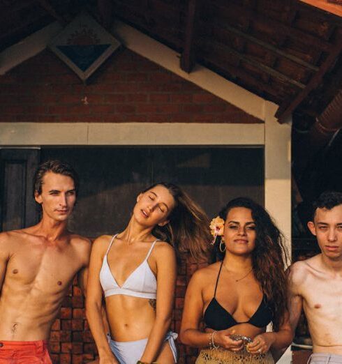 Swimsuits - 3 Men and 3 Women Standing Near Brown Wooden Wall