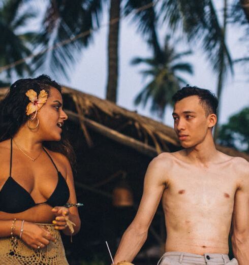 Swimsuits - Topless Man in Brown and Black Leopard Print Bikini Bottom Sitting on Brown Wooden Bench during