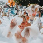 Swimsuits - A group of people in bathing suits and foam