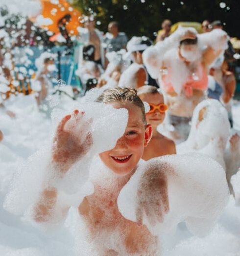 Swimsuits - A group of people in bathing suits and foam