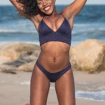 Swimwear - Photo of Happy Woman in Two Piece Bikini Jumping on Shore