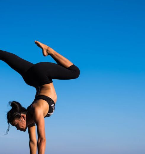 Wellness - Woman With Arms Outstretched Against Blue Sky