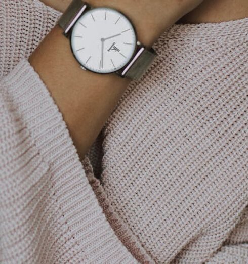 Necklace - Woman Wearing Beige Crochet Sweater and Round White Analog Watch Closeup Photo