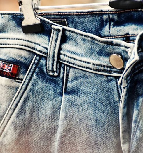 Jeans - Selective Focus Photography of Blue Denim Bottoms Hanged on Gray Metal Hanger