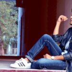 Jeans - Man Wearing Black Leather Jacket and Blue Jeans Sitting on Floor