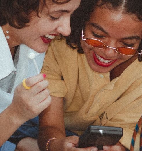 Vintage Fashion - Shallow Focus Photo of Woman Using Game boy