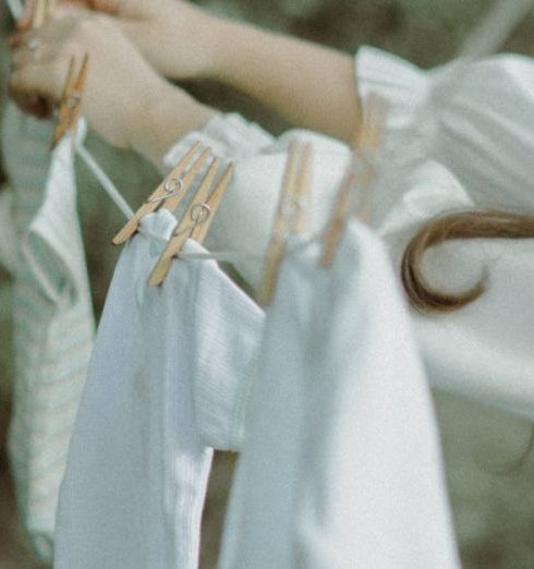 Maternity Clothes - Pregnant Woman Hanging Baby Clothes on a Clothesline