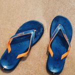 Footwear - Top View Photo of Slippers On Seashore