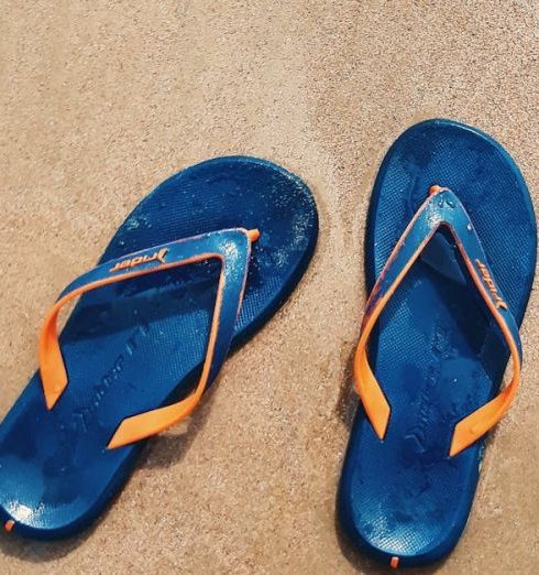 Footwear - Top View Photo of Slippers On Seashore