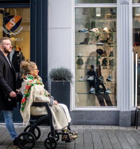 Street Style Stores - Man Pulling Woman in Wheelchair