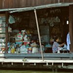 Home Goods Store - Woman Sitting and Working in Store by Water