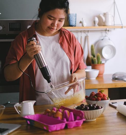 Kitchen Gadgets - A Woman Beating Eggs