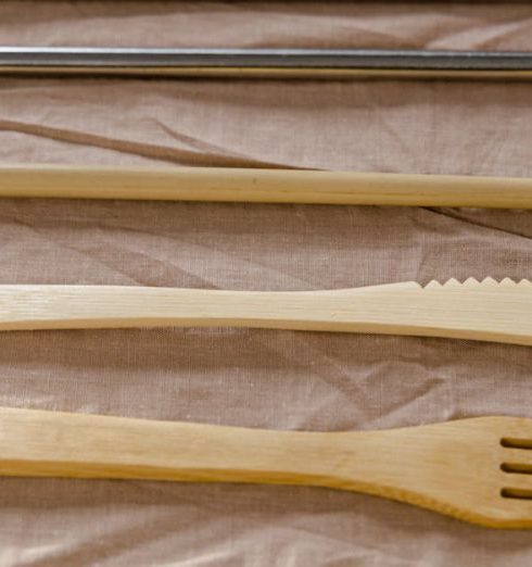 Home Goods - Wooden Utensils and Stainless Straws on a Brown Textile