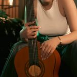 Modern Furniture - Woman in Tank Top Sitting with Guitar