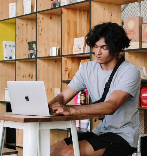 Shelving - Man in White Crew Neck T-shirt Sitting on White Wooden Chair