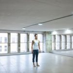 Wall Mirrors - Man in White Tank Top Standing on a Studio