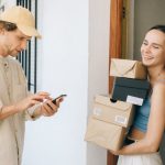 Subscription Boxes - Woman in Blue Tank Top Carrying Brown Boxes