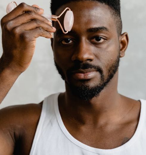 Facials - A Man Holding a Face Roller