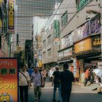 Electronics Stores - View of People Walking on a Street in a Japanese City