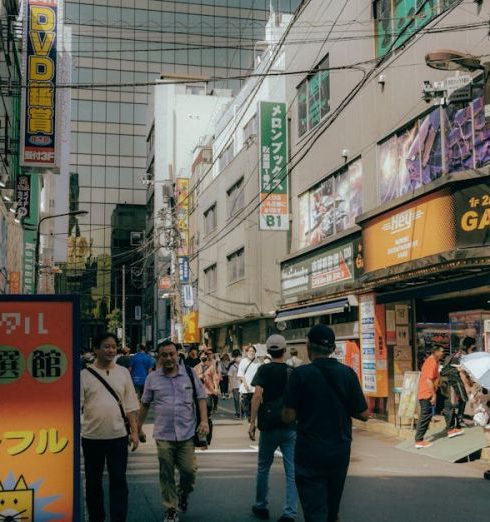 Electronics Stores - View of People Walking on a Street in a Japanese City