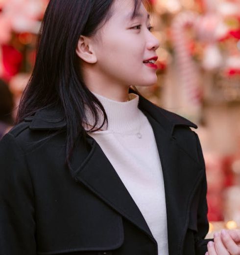 Gift Shopping - Young Woman in a Black Coat Over a White Sweater Doing Christmas Shopping