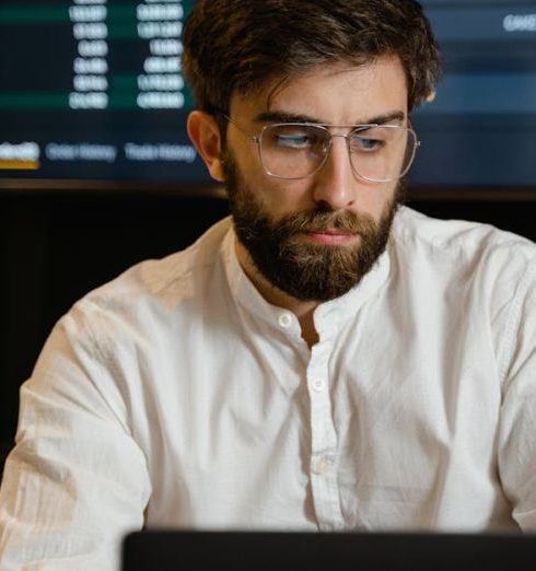 Trade-In Programs - Man in White Dress Shirt Wearing Eyeglasses Using A Laptop