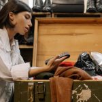 Consignment Boutiques - Woman Looking at the Coin Purse from the Wooden Box